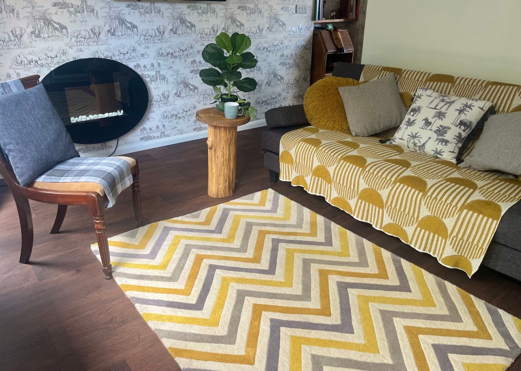 A cosy counselling room in Wheldrake, with a sofa and chair and a plant in the corner 