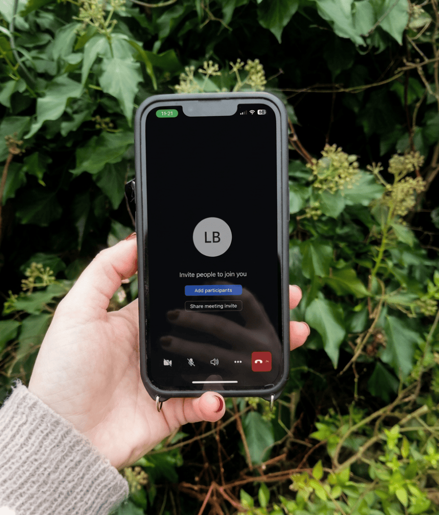 person holding a phone outdoors